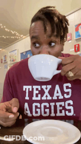 Man In Texas Aggies Shirt Drinking From Cup GIF