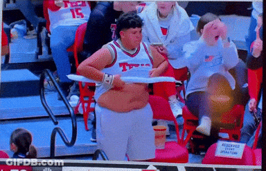 Man In Texas Jersey Holding Towel Over Stomach GIF