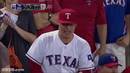 Man In Texas Jersey Talking On Phone GIF