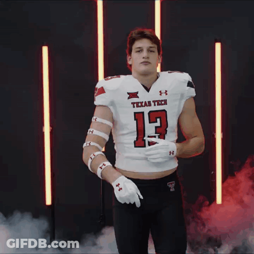 Man In Texas Tech Football Jersey Pointing GIF