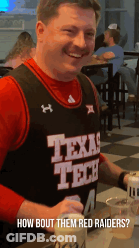 Man In Texas Tech Jersey Sitting At Table GIF