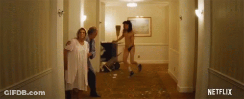 Man In Thong Sweeping Floor While Women Look On GIF
