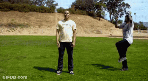 Man In Thrasher Shirt Jumping In Field GIF