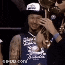 Man In Thunder Jersey Holding Trophy, Onlooker GIF