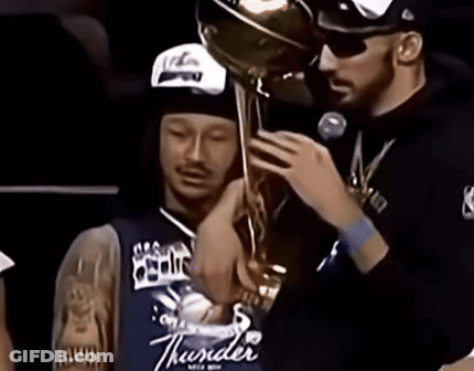 Man In Thunder Jersey Holding Trophy Over Another Man GIF