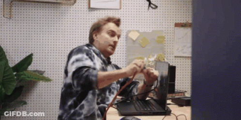 Man In Tie Dye Shirt Fixing Laptop GIF