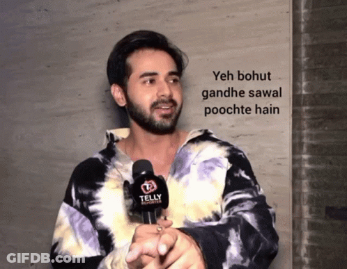 Man In Tie Dye Shirt Holding Telly Reporter GIF