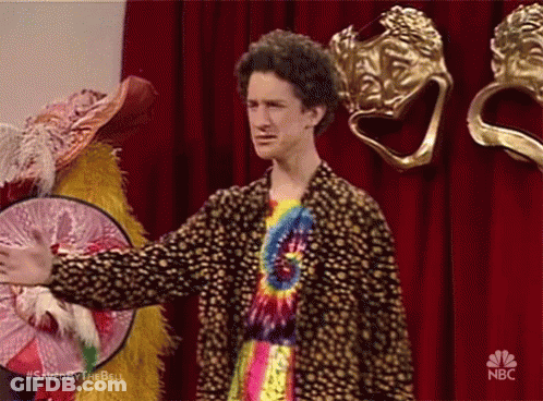 Man In Tie Dye Shirt In Front Of Red Curtain NBC GIF