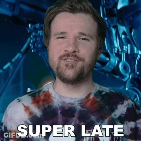 Man In Tie Dye Shirt Says Super Late To Robot GIF