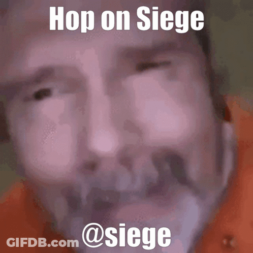 Man In Tie Dye Shirt Standing In Front Of Mirror GIF