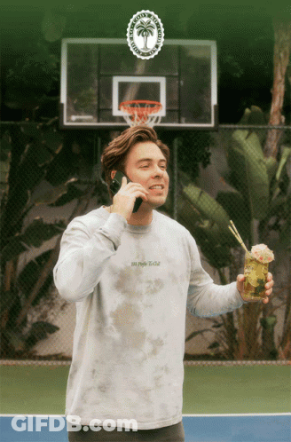 Man In Tie Dye Shirt Talking On Cell Phone GIF