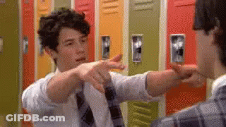 Man In Tie Pointing At Another Man By Lockers GIF