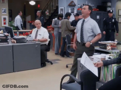 Man In Tie Standing In Front Of Emergency Sign GIF