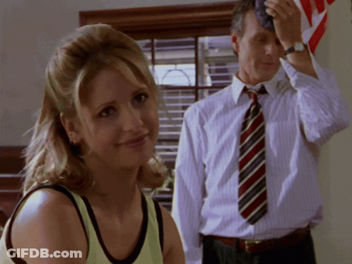 Man In Tie Wipes Forehead Woman Watches GIF