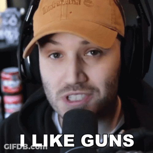 Man In Timberland Hat And Headphones Says I Like Guns GIF