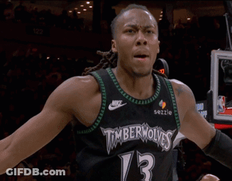 Man In Timberwolves Jersey In Front Of Tissot Scoreboard GIF