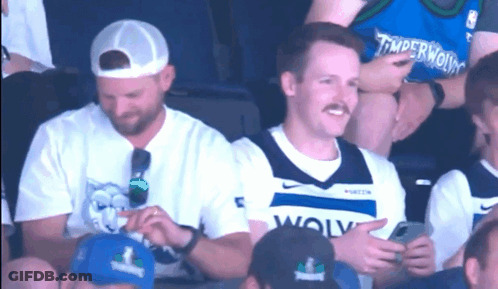 Man In Timberwolves Jersey Sitting GIF