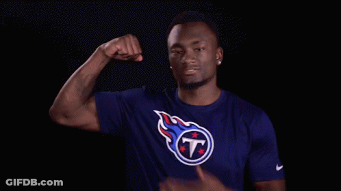 Man In Titans Shirt Flexing Arm GIF