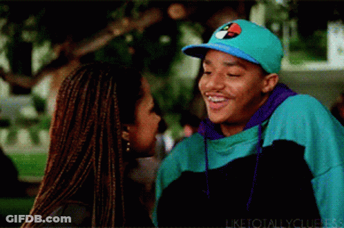 Man In Tommy Hilfiger Hat Smiling Next To Woman GIF