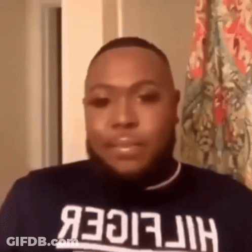 Man In Tommy Hilfiger Shirt Looking At Camera GIF