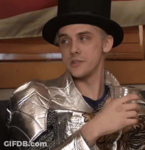 Man In Top Hat And Armor Holding Drink GIF