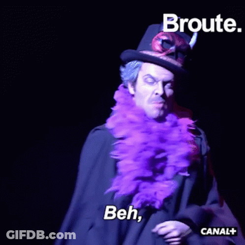 Man In Top Hat And Purple Feather Boa Saying Beh GIF