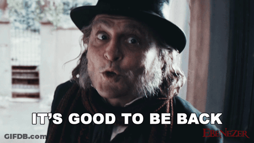 Man In Top Hat And Scarf Says It's Good To Be Back GIF