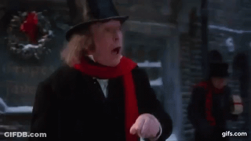 Man In Top Hat And Scarf Walking Down Street In Christmas Story GIF