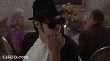 Man In Top Hat And Sunglasses Sitting At Table With Candle GIF