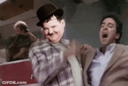 Man In Top Hat Dancing With Suited Man GIF
