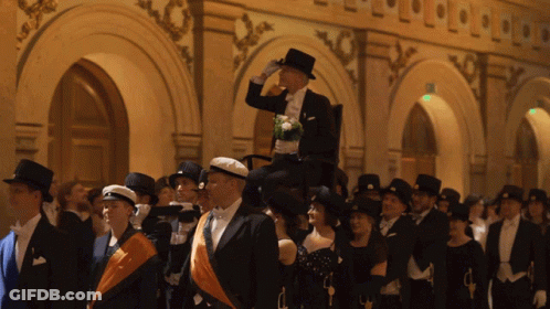 Man In Top Hat Holding Dog On Shoulders GIF