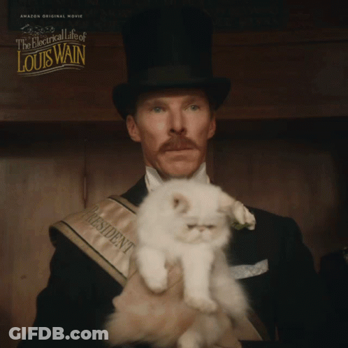 Man In Top Hat Holding Small White Cat The Electrical Life Of Louis Wain GIF
