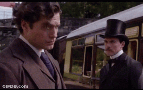 Man In Top Hat Next To Man In Suit GIF