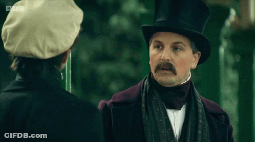 Man In Top Hat Says I'm Confused Talking To Another Man GIF