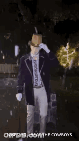 Man In Top Hat Standing In Dark With Light Behind Him Says When You Beat The Cowboys GIF