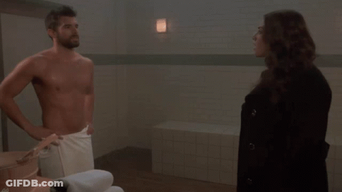 Man In Towel Standing Next To Woman GIF