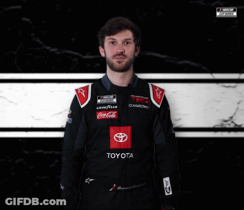 Man In Toyota Racing Suit In Front Of NASCAR Logo GIF