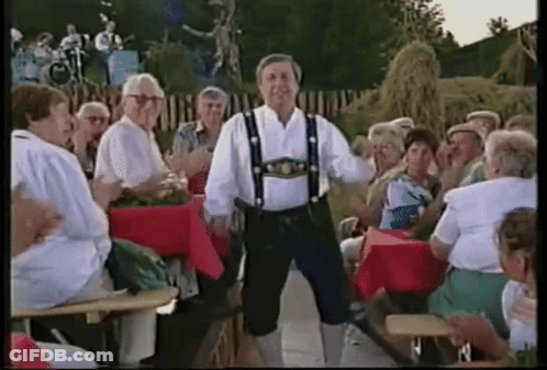Man In Traditional Costume Dancing In Front Of Crowd GIF