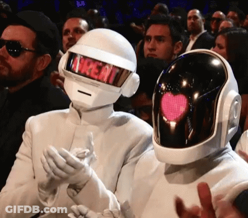 Man In Treat Helmet Next To Man In Heart Helmet GIF