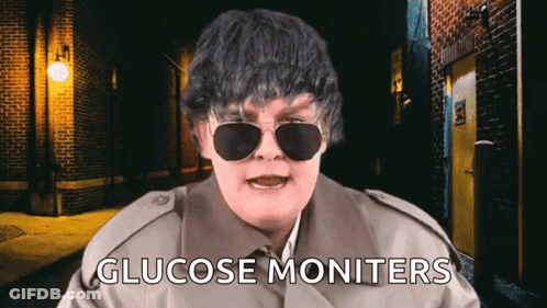 Man In Trench Coat And Sunglasses Says Glucose Monitors GIF