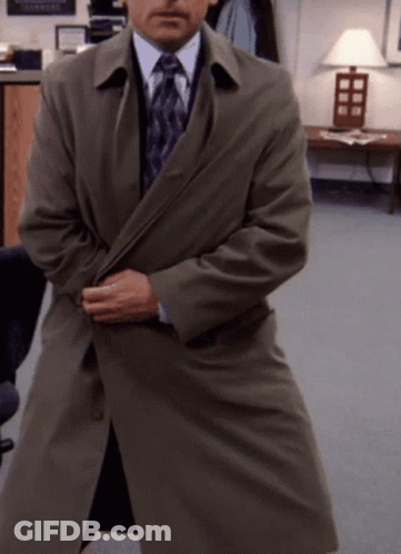 Man In Trench Coat And Tie By Lamp GIF