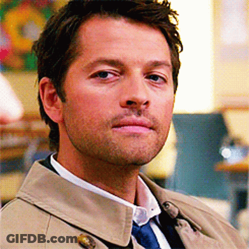 Man In Trench Coat And Tie Looking At Camera GIF
