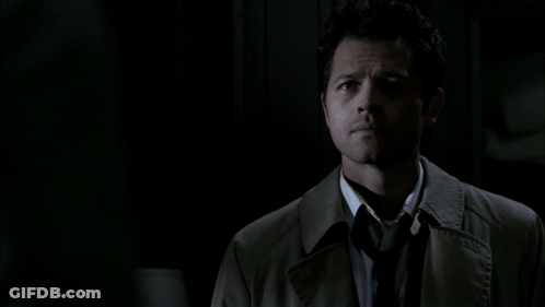 Man In Trench Coat And Tie Looks At Camera GIF