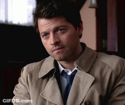 Man In Trench Coat And Tie Looks Serious GIF