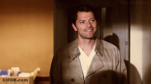Man In Trench Coat And White Shirt Smiling GIF