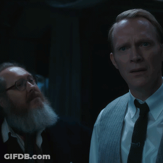 Man In Trench Coat Dancing In Front Of Woman GIF