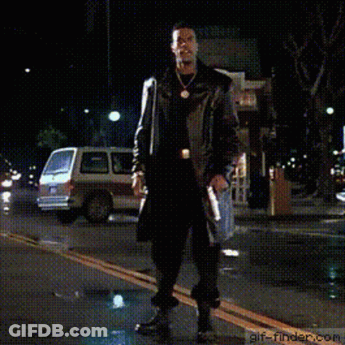 Man In Trench Coat Dancing On Street At Night GIF