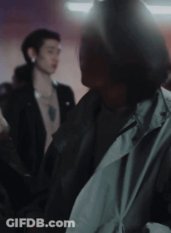Man In Trench Coat In Crowd GIF