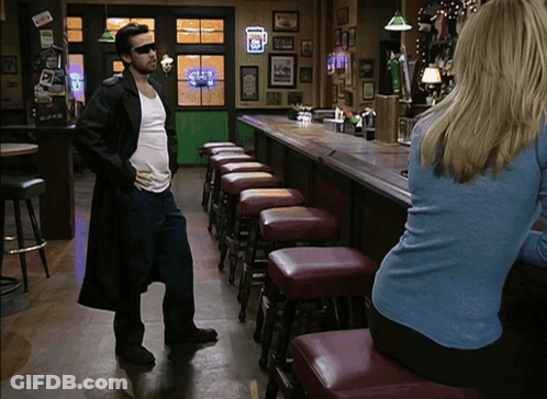 Man In Trench Coat In Front Of Guinness Bar GIF