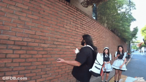 Man In Trench Coat Kneeling On Stairs GIF